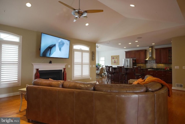 32314 Deep Meadow Ln, Locust Grove, VA 22508 - living room with a ceiling fan, vaulted ceiling, light wood-type flooring, a fireplace, and baseboards