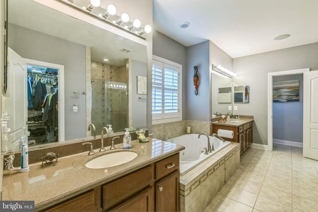 32314 Deep Meadow Ln, Locust Grove, VA 22508 - full bathroom featuring a shower stall, a garden tub, tile patterned flooring, two vanities, and a walk in closet