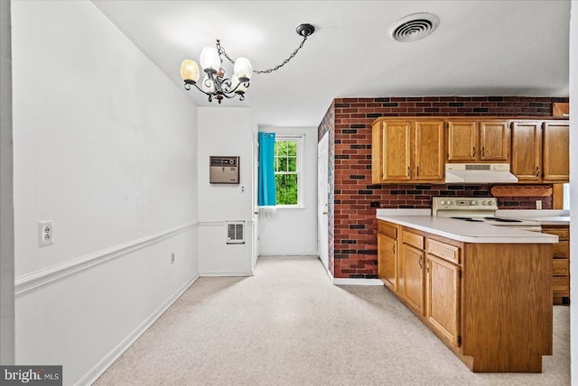 9309 Old Tpke, Culpeper, VA 22701 - kitchen with under cabinet range hood, white electric range, a chandelier, a peninsula, and light countertops