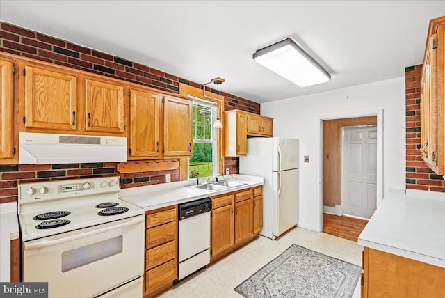 9309 Old Tpke, Culpeper, VA 22701 - kitchen featuring white appliances, under cabinet range hood, light countertops, hanging light fixtures, and brick wall