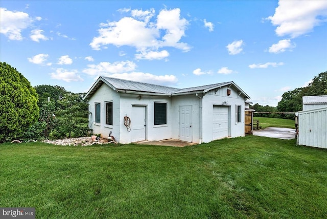 9309 Old Tpke, Culpeper, VA 22701 - rear view of property featuring a yard, stucco siding, an attached garage, and a metal roof