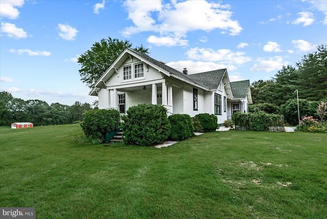 9309 Old Tpke, Culpeper, VA 22701 - view of side of property featuring stucco siding, a yard, a shingled roof, and a chimney