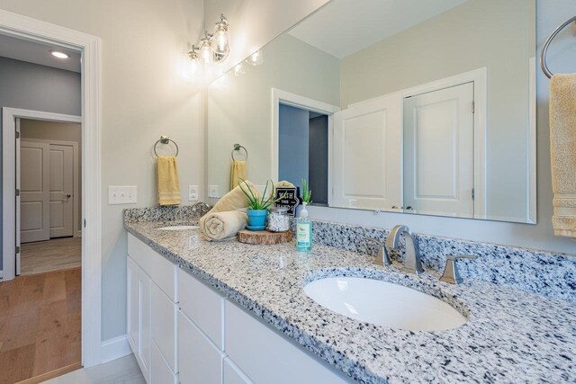 14758 Green View Dr, Elkton, VA 22827 - bathroom featuring double vanity, baseboards, and a chandelier