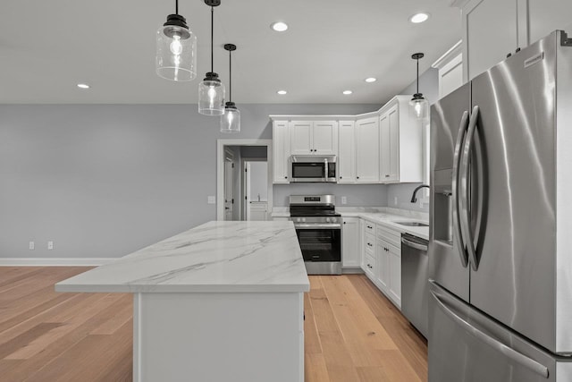 14758 Green View Dr, Elkton, VA 22827 - kitchen featuring appliances with stainless steel finishes, a sink, a center island, light wood finished floors, and white cabinets