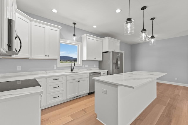 14758 Green View Dr, Elkton, VA 22827 - kitchen featuring appliances with stainless steel finishes, a sink, light wood-style floors, a kitchen island, and white cabinetry