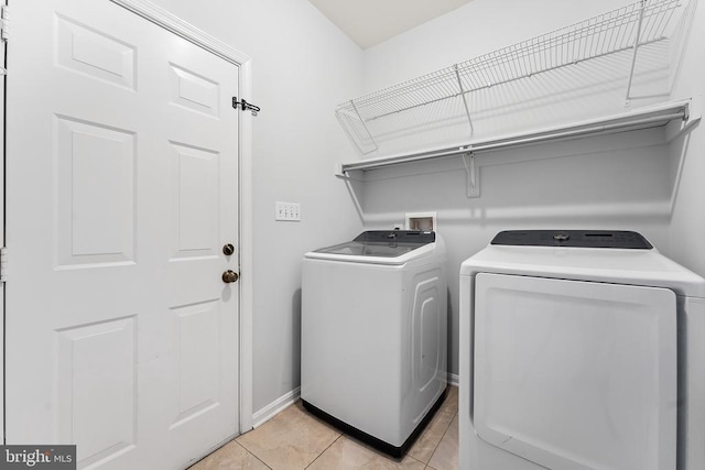 10614 Rhoads Dr, Fredericksburg, VA 22407 - washroom with independent washer and dryer, light tile patterned floors, and baseboards