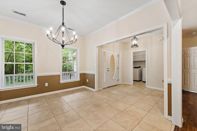 10614 Rhoads Dr, Fredericksburg, VA 22407 - unfurnished dining area with a chandelier, light tile patterned floors, crown molding, baseboards, and independent washer and dryer
