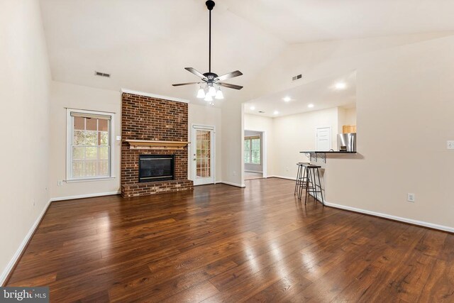 10614 Rhoads Dr, Fredericksburg, VA 22407 - unfurnished living room featuring dark wood-style floors, ceiling fan, baseboards, a brick fireplace, and high vaulted ceiling