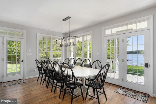 326 Anna Highview, Bumpass, VA 23024 - dining area with wood-type flooring, a water view, a chandelier, and baseboards