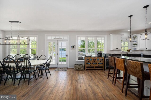326 Anna Highview, Bumpass, VA 23024 - dining area featuring a chandelier, dark wood finished floors, and baseboards