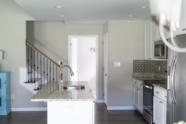 133 Lake View Cir, Waynesboro, VA 22980 - kitchen featuring appliances with stainless steel finishes, white cabinetry, dark wood-type flooring, a kitchen island with sink, and light stone countertops