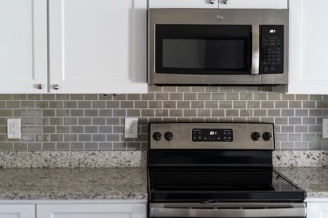 133 Lake View Cir, Waynesboro, VA 22980 - kitchen view of appliances with stainless steel finishes, backsplash, and white cabinetry