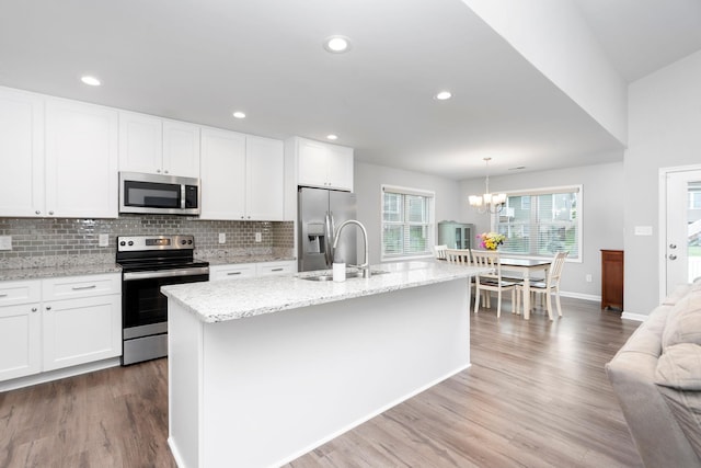 133 Lake View Cir, Waynesboro, VA 22980 - kitchen featuring stainless steel appliances, wood finished floors, backsplash, a chandelier, and white cabinets
