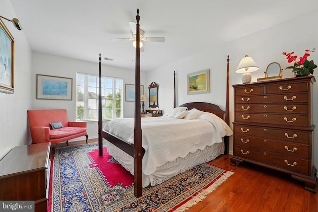 bedroom featuring dark wood-style flooring, ceiling fan, and baseboards