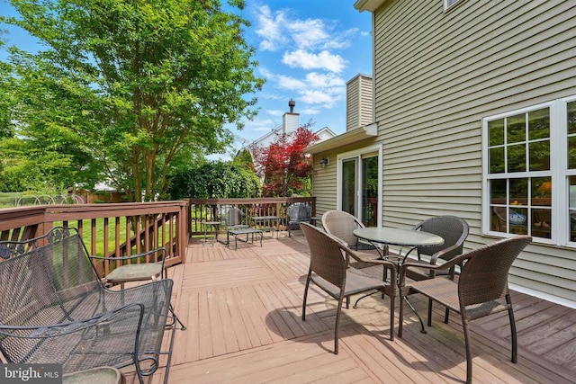 deck with outdoor dining area