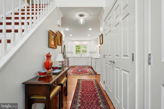 hallway featuring wood finished floors and recessed lighting