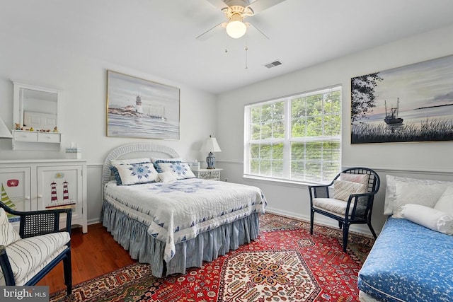 bedroom with baseboards, wood finished floors, and ceiling fan