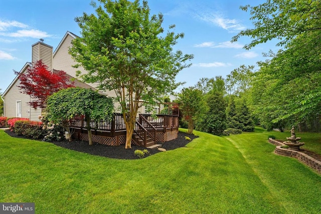 view of grassy yard featuring a deck