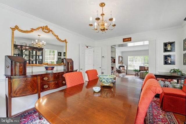 dining room with a chandelier, crown molding, and plenty of natural light