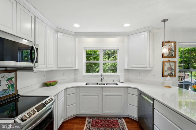kitchen with a sink, appliances with stainless steel finishes, plenty of natural light, white cabinets, and recessed lighting