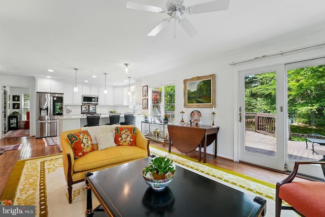 living area with wood finished floors, recessed lighting, and ceiling fan