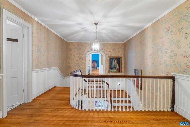 3220 Longdale Furnace Rd, Clifton Forge, VA 24422 - hallway featuring an upstairs landing, a wainscoted wall, wood finished floors, wallpapered walls, and ornamental molding