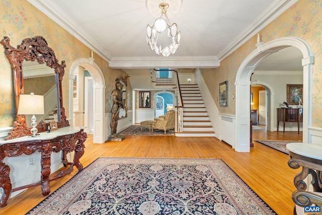 3220 Longdale Furnace Rd, Clifton Forge, VA 24422 - entryway with wood finished floors, stairway, arched walkways, wainscoting, and crown molding