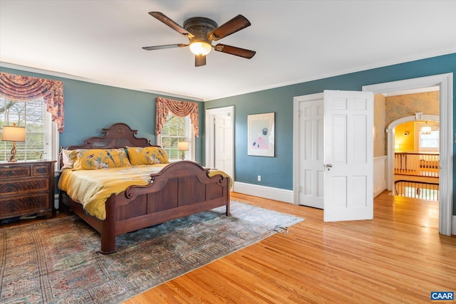 3220 Longdale Furnace Rd, Clifton Forge, VA 24422 - bedroom with wood finished floors, baseboards, ornamental molding, ceiling fan, and arched walkways