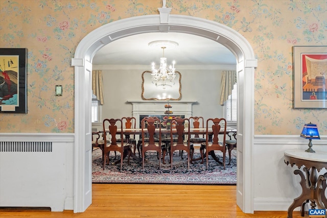 3220 Longdale Furnace Rd, Clifton Forge, VA 24422 - dining area with wood finished floors, arched walkways, a chandelier, wainscoting, and wallpapered walls