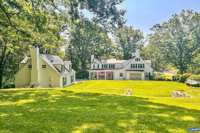 3220 Longdale Furnace Rd, Clifton Forge, VA 24422 - view of front facade with a standing seam roof, a chimney, a front yard, metal roof, and view of wooded area