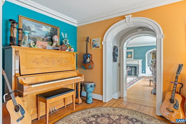 3220 Longdale Furnace Rd, Clifton Forge, VA 24422 - living area with crown molding, baseboards, wood finished floors, a high end fireplace, and arched walkways