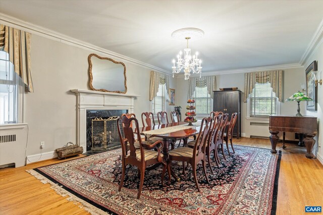 3220 Longdale Furnace Rd, Clifton Forge, VA 24422 - dining space featuring a chandelier, wood finished floors, crown molding, radiator heating unit, and a fireplace