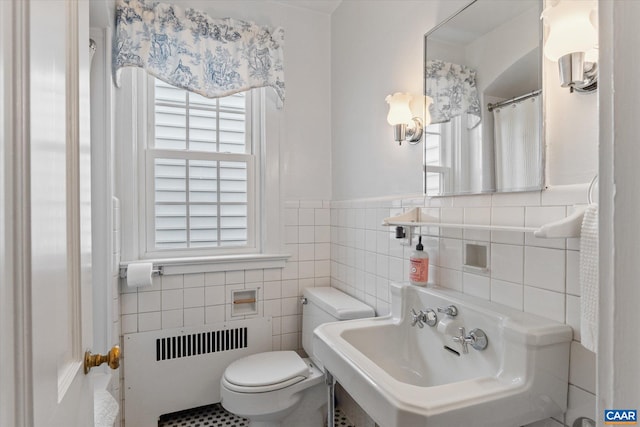 3220 Longdale Furnace Rd, Clifton Forge, VA 24422 - full bathroom featuring radiator heating unit, toilet, a sink, tile walls, and wainscoting