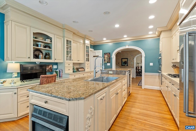 3220 Longdale Furnace Rd, Clifton Forge, VA 24422 - kitchen featuring a sink, arched walkways, crown molding, a center island with sink, and light wood-style flooring