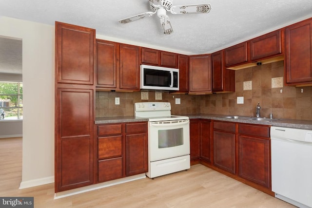 2 Short Cir, Fredericksburg, VA 22407 - kitchen with white appliances, a sink, dark brown cabinets, light wood-style floors, and tasteful backsplash