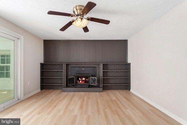 2 Short Cir, Fredericksburg, VA 22407 - unfurnished living room with baseboards, wood finished floors, a brick fireplace, and a ceiling fan