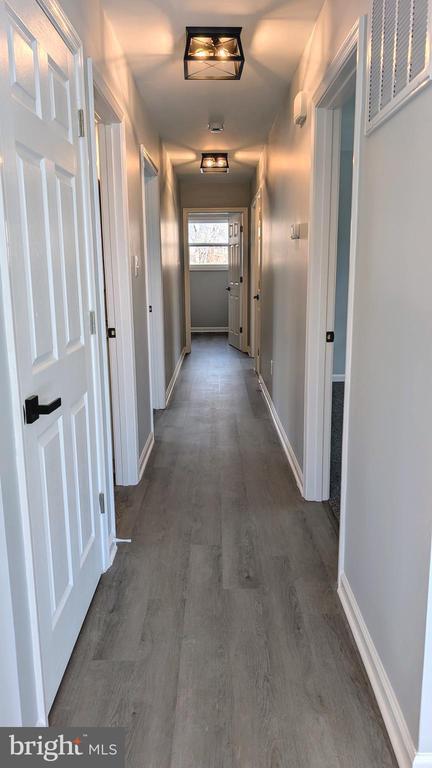 176 Tussing Ln, Rochelle, VA 22738 - hallway with dark wood-style floors and baseboards