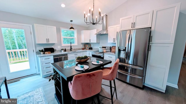 176 Tussing Ln, Rochelle, VA 22738 - kitchen with appliances with stainless steel finishes, wall chimney exhaust hood, a sink, a chandelier, and light wood finished floors