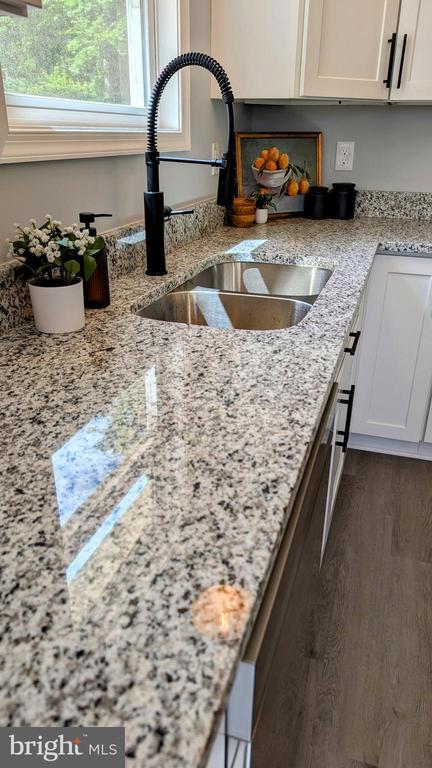 176 Tussing Ln, Rochelle, VA 22738 - kitchen view of a sink, white cabinets, and light stone countertops