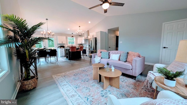 176 Tussing Ln, Rochelle, VA 22738 - living room featuring a chandelier, light wood-type flooring, vaulted ceiling, a ceiling fan, and baseboards