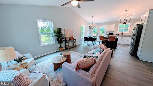176 Tussing Ln, Rochelle, VA 22738 - living room featuring a chandelier, vaulted ceiling, light wood-type flooring, baseboards, and a ceiling fan