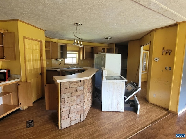 kitchen featuring dark wood-style flooring, a textured ceiling, open shelves, and a center island