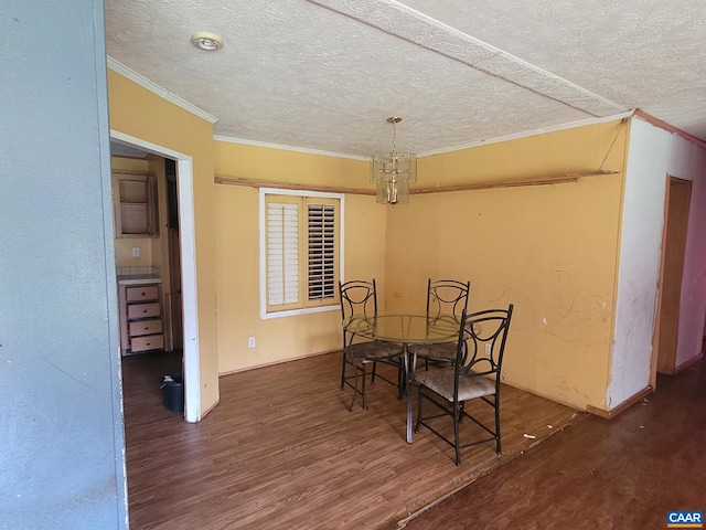 dining area featuring crown molding, a textured ceiling, baseboards, and wood finished floors