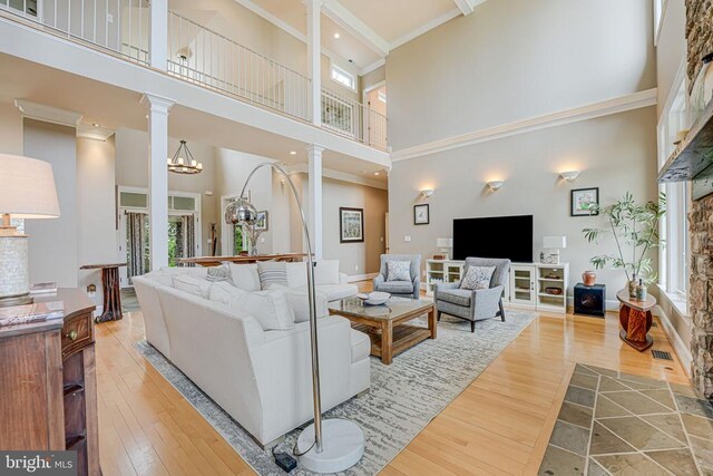 87 River Bend Rd E, Fredericksburg, VA 22407 - living room with decorative columns, a high ceiling, wood-type flooring, and ornamental molding