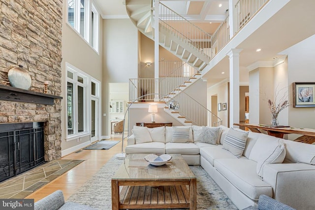 87 River Bend Rd E, Fredericksburg, VA 22407 - living area with a high ceiling, stairs, wood finished floors, a fireplace, and crown molding