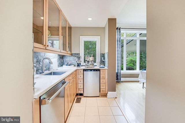 87 River Bend Rd E, Fredericksburg, VA 22407 - kitchen featuring dishwasher, a sink, light countertops, light tile patterned floors, and glass insert cabinets