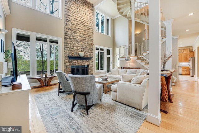 87 River Bend Rd E, Fredericksburg, VA 22407 - living room with plenty of natural light, a towering ceiling, wood-type flooring, stairs, and a fireplace