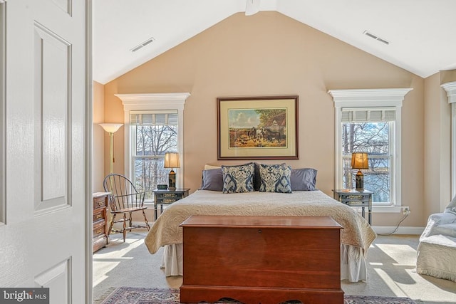 bedroom featuring light colored carpet, visible vents, and vaulted ceiling