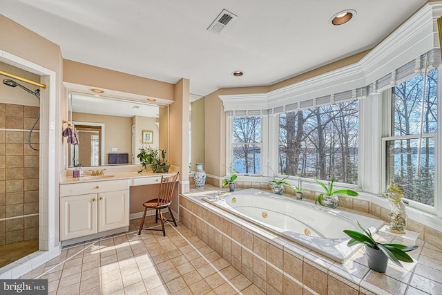 full bathroom featuring a tub with jets, tiled shower, a healthy amount of sunlight, and visible vents