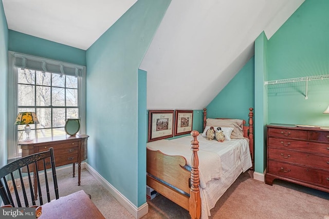 bedroom with baseboards, lofted ceiling, and carpet floors